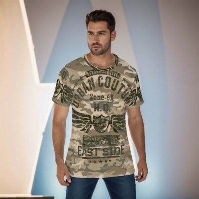 Man wearing camouflage all-over print O-neck T-shirt with graphic text in urban setting.