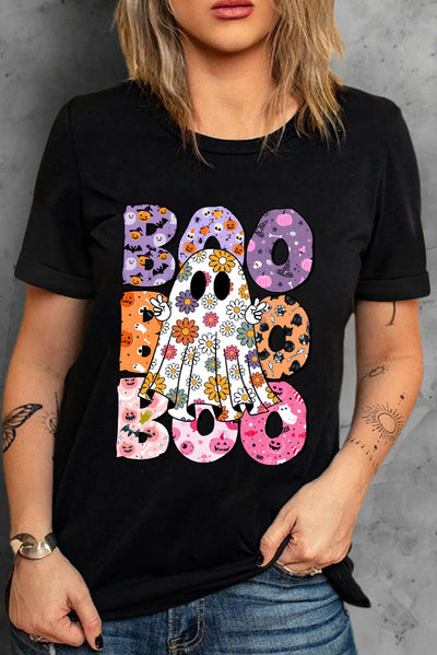 Woman wearing BOO ghost graphic round neck short sleeve t-shirt with colorful floral design on black fabric.