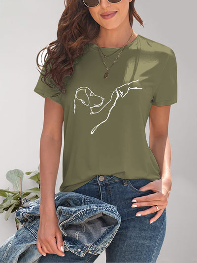 Woman wearing olive green dog graphic round neck t-shirt with slightly stretchy fit, paired with jeans and sunglasses.