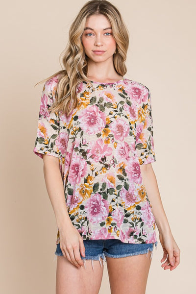 Woman wearing BOMBOM Floral Round Neck T-Shirt with pink rose print, paired with denim shorts for a casual look.